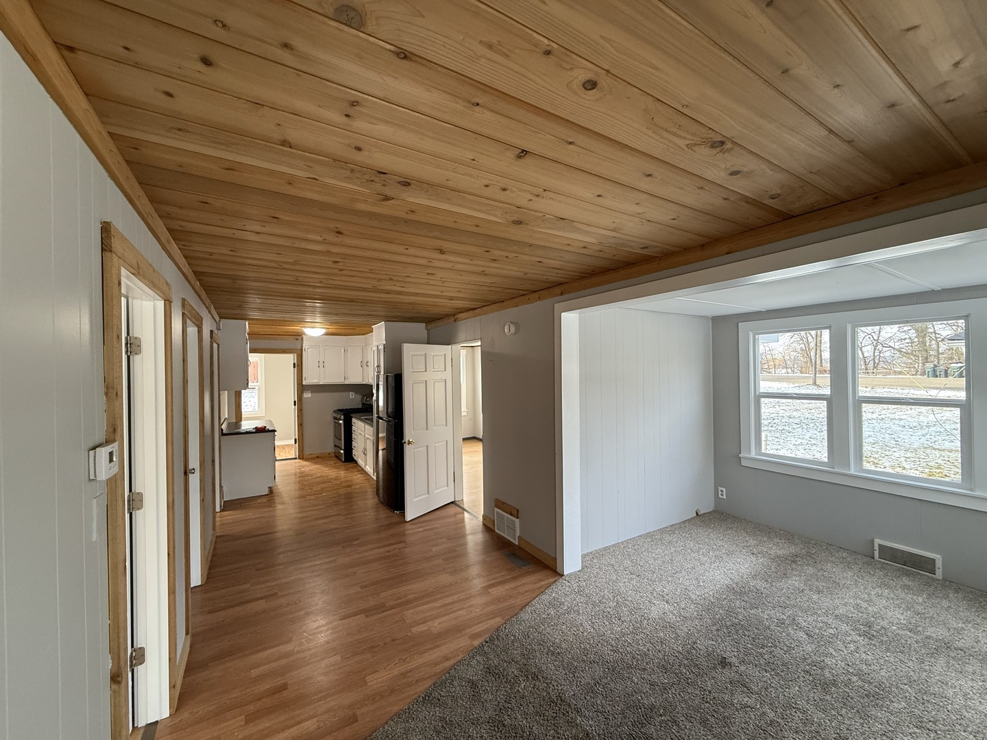 3717 State Line Road, Unit B Richmond, IL 60071 - Photo 14 of 20 a view of empty room with wooden floor and fan