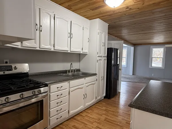 a kitchen with granite countertop a stove and a refrigerator