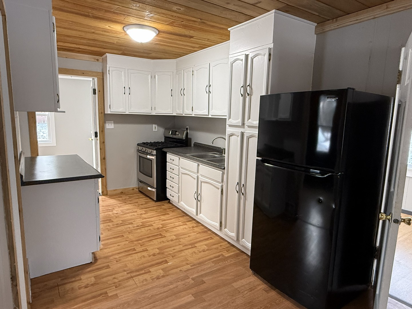 3717 State Line Road, Unit B Richmond, IL 60071 - Photo 7 of 20 a kitchen with stainless steel appliances a refrigerator a sink a stove a microwave and cabinets