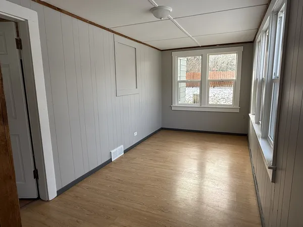 a view of room with window and hardwood floor