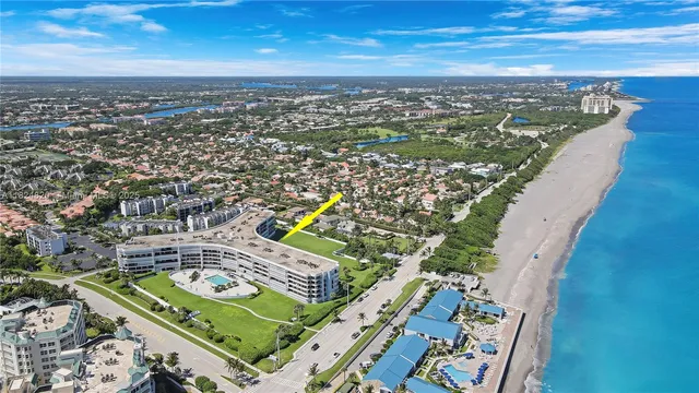 a view of a big building with a big yard and large trees