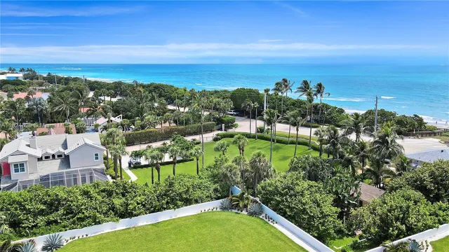 a front view of multi story residential apartment building with yard and green space
