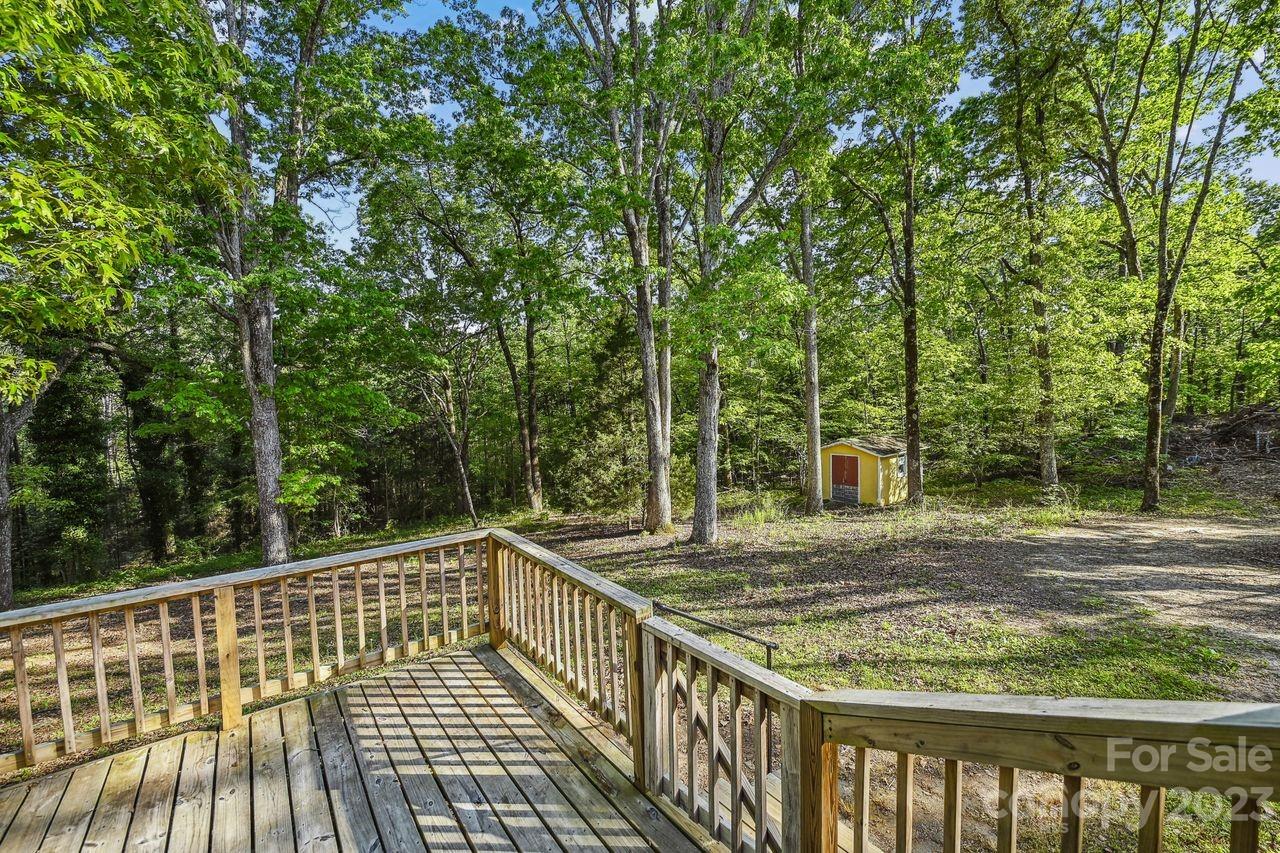 3710 Benjamin Street Richburg, SC 29729 - Photo 11 of 35 a view of a wooden deck with large trees