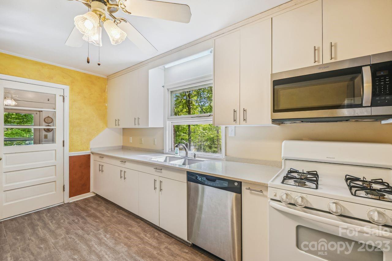 3710 Benjamin Street Richburg, SC 29729 - Photo 19 of 35 a kitchen with stainless steel appliances granite countertop a stove a sink and a microwave