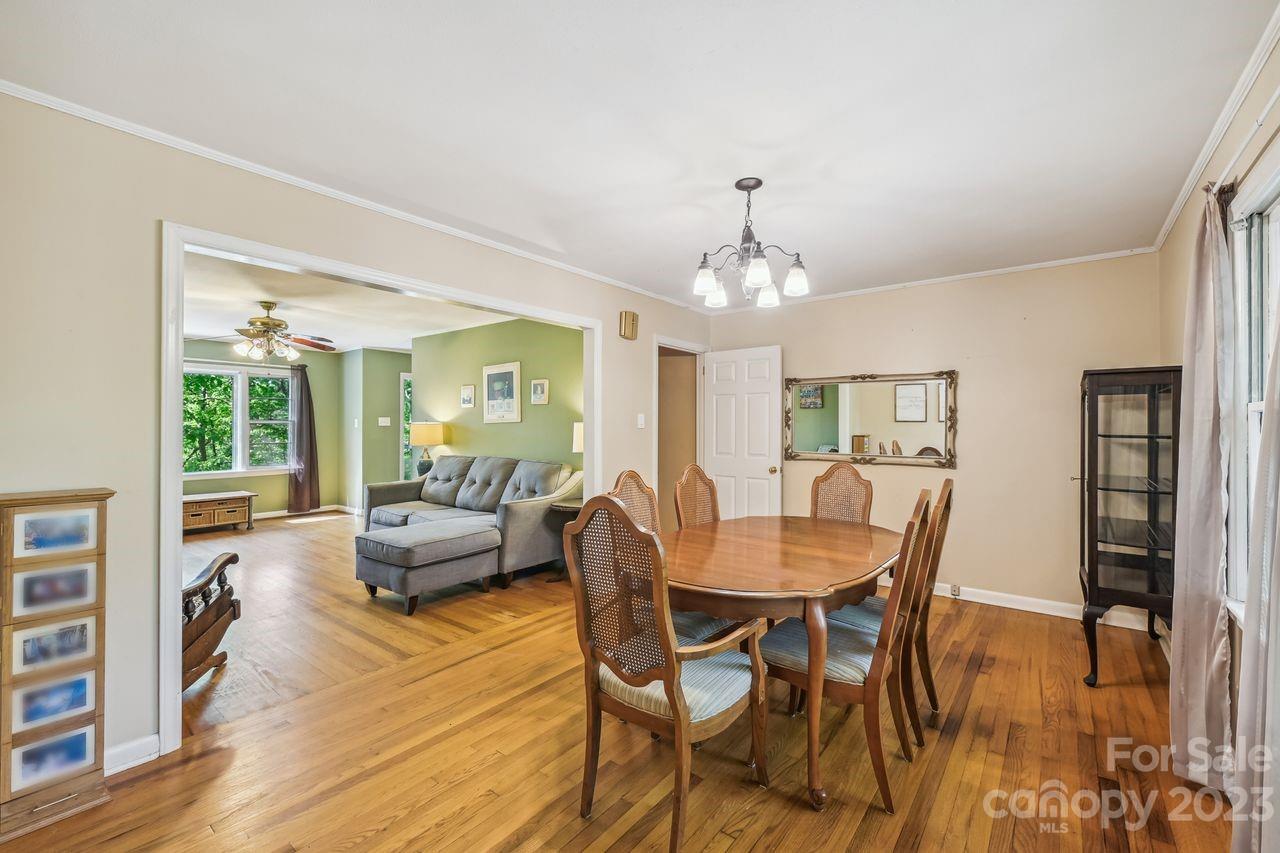 3710 Benjamin Street Richburg, SC 29729 - Photo 22 of 35 a dining room with wooden floor a chandelier a wooden table and chairs
