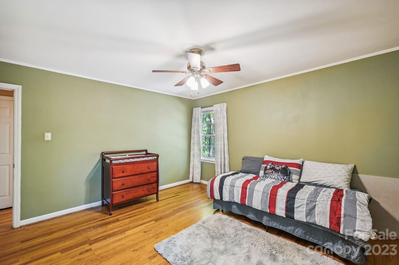3710 Benjamin Street Richburg, SC 29729 - Photo 27 of 35 a bedroom with a bed dresser and a chandelier