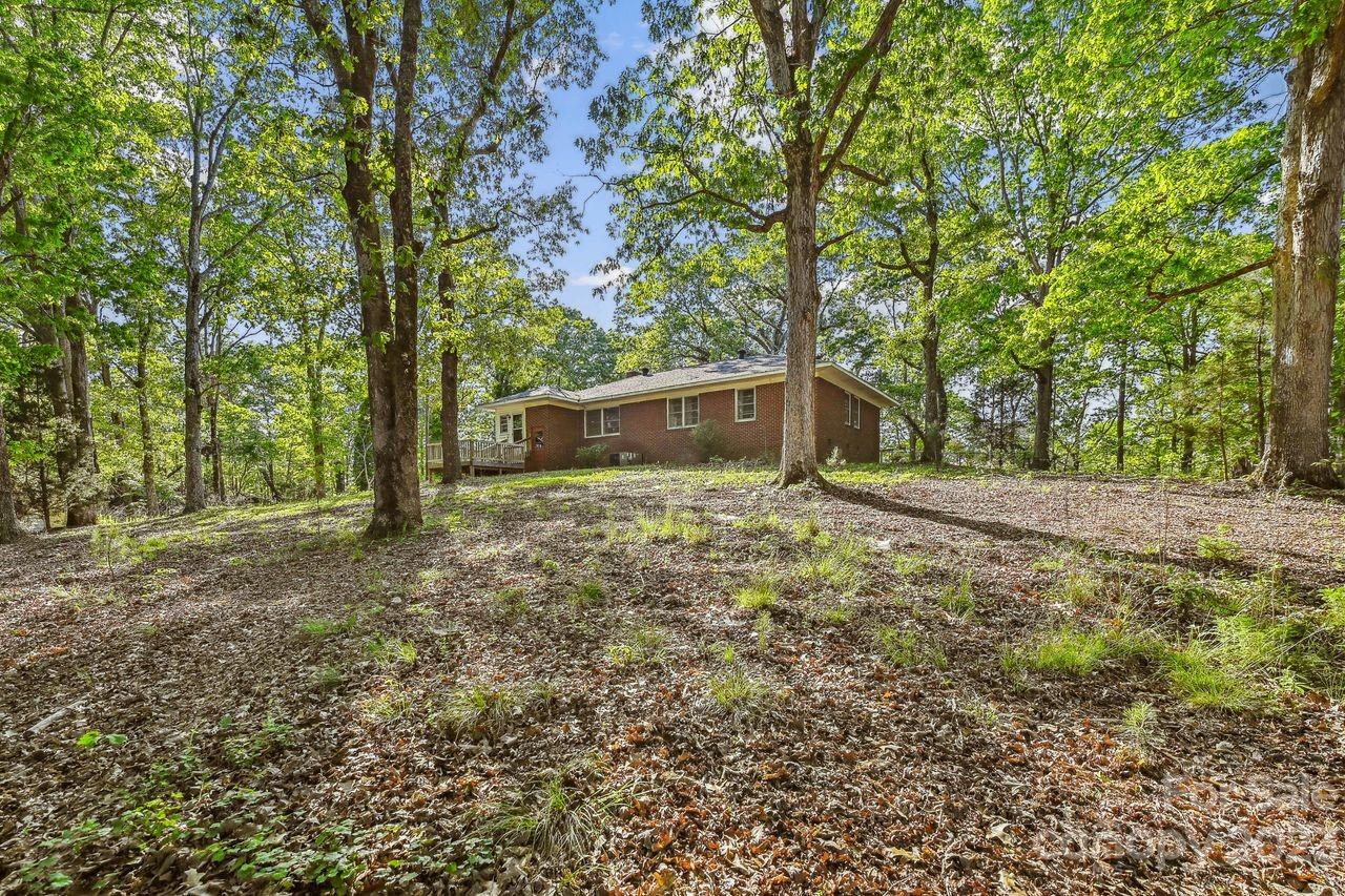 3710 Benjamin Street Richburg, SC 29729 - Photo 3 of 35 a backyard of a house with large trees and a yard