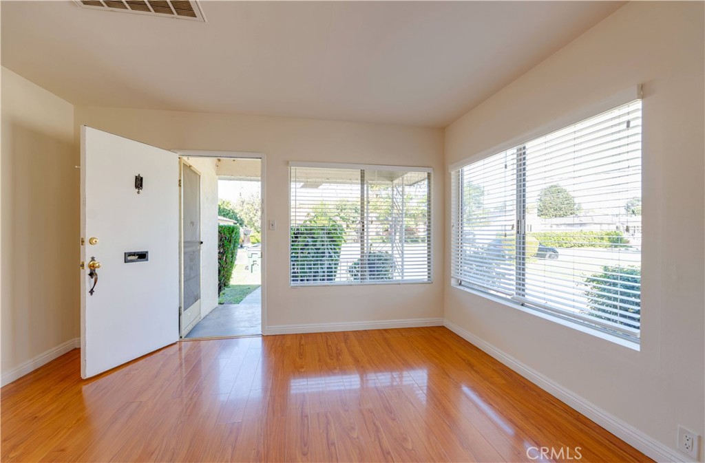 9816 Key W Street Temple City, CA 91780 - Photo 2 of 15 an empty room with wooden floor and windows