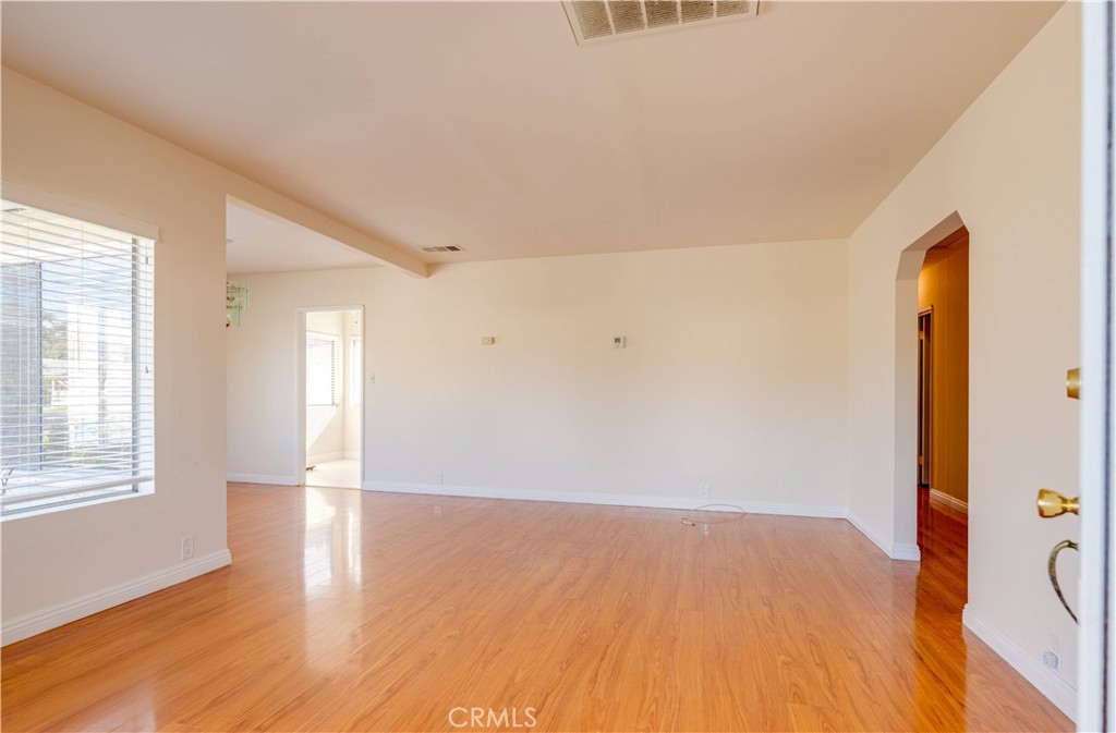 9816 Key W Street Temple City, CA 91780 - Photo 3 of 15 an empty room with wooden floor and windows