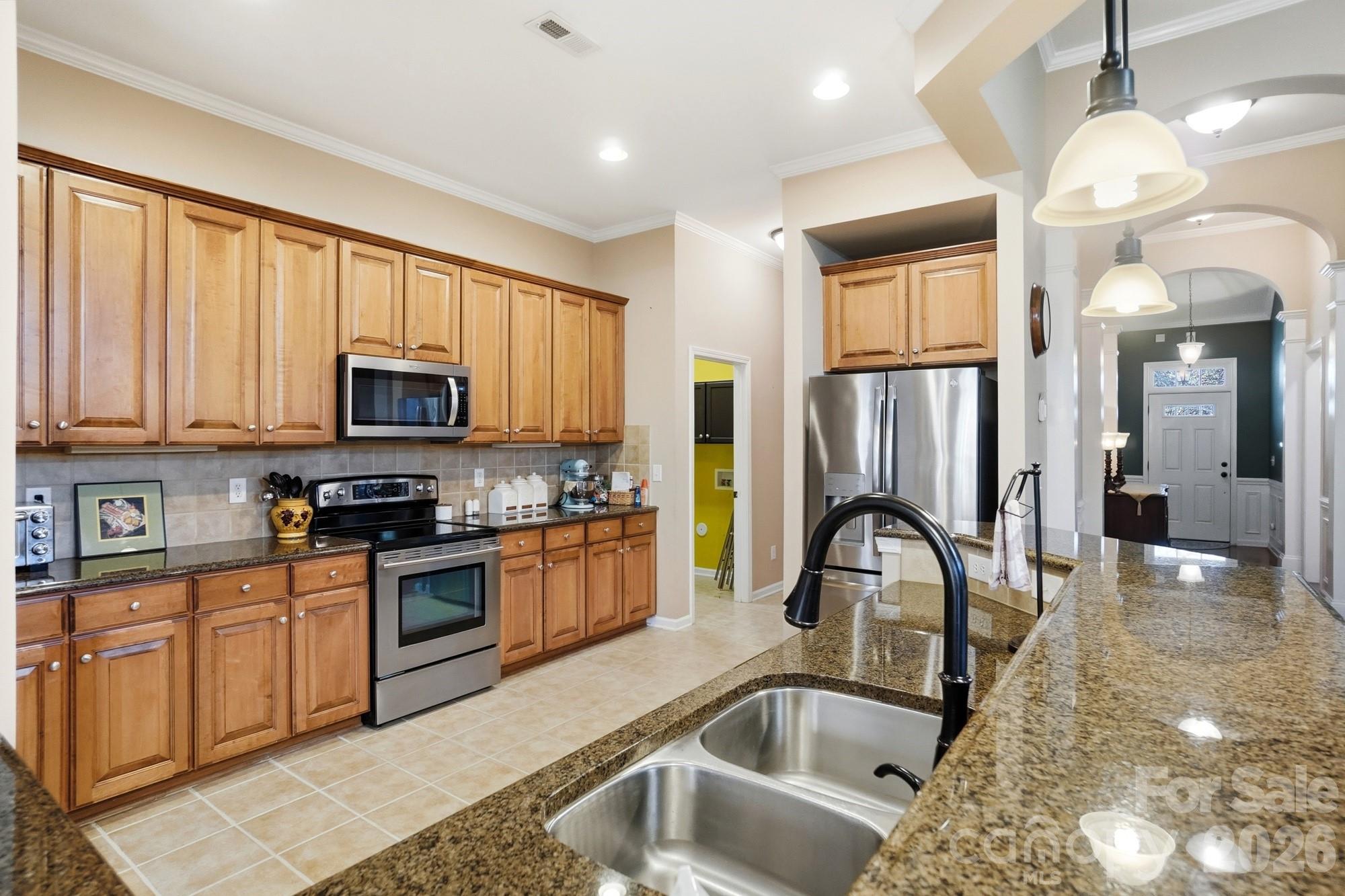 425 Silver Cypress Lane Fort Mill, SC 29708 - Photo 13 of 40 a kitchen with stainless steel appliances granite countertop a sink a stove and a refrigerator