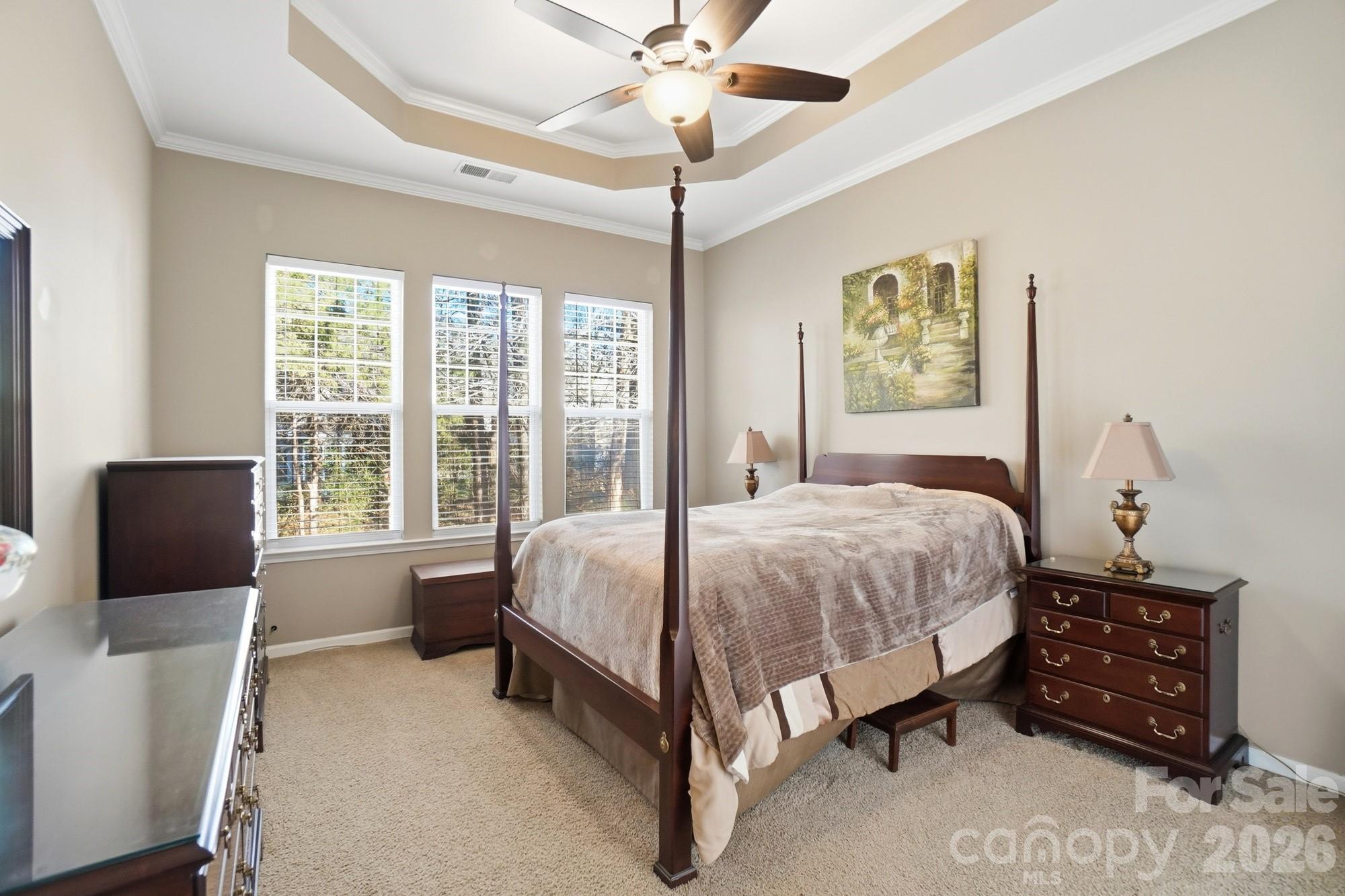 425 Silver Cypress Lane Fort Mill, SC 29708 - Photo 16 of 40 a spacious bedroom with a bed and a chandelier
