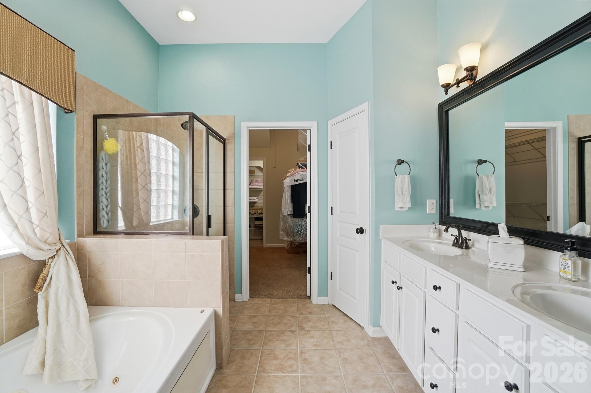 425 Silver Cypress Lane Fort Mill, SC 29708 - Photo 19 of 40 a en suite bathroom with a double vanity sink and a mirror