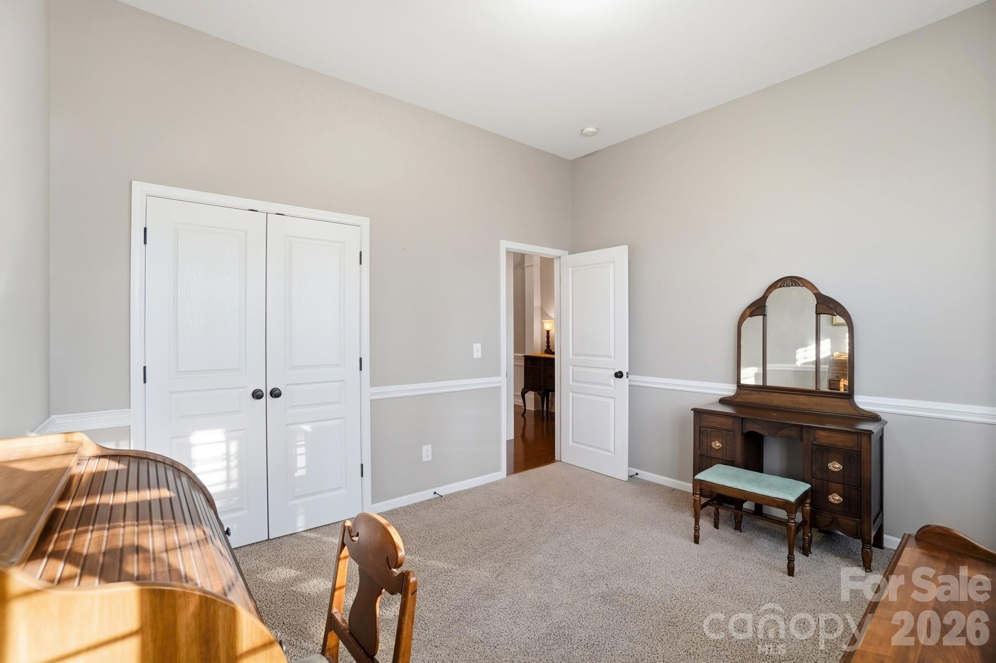 425 Silver Cypress Lane Fort Mill, SC 29708 - Photo 25 of 40 a bedroom with a bed and a chandelier