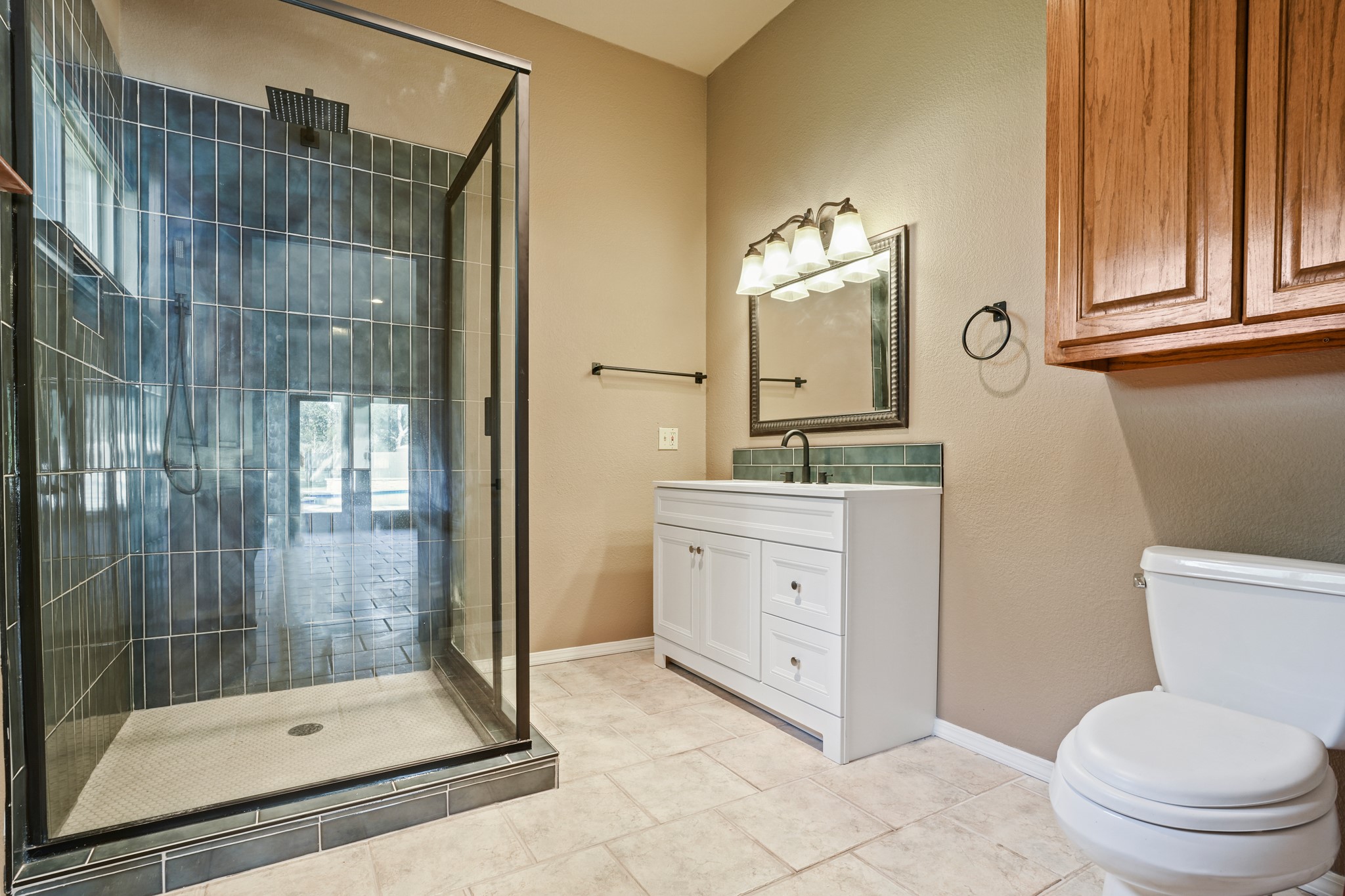 176 Logan Ranch Road Georgetown, TX 78628 - Photo 31 of 38 Full bath featuring a stall shower, vanity, and tile patterned flooring