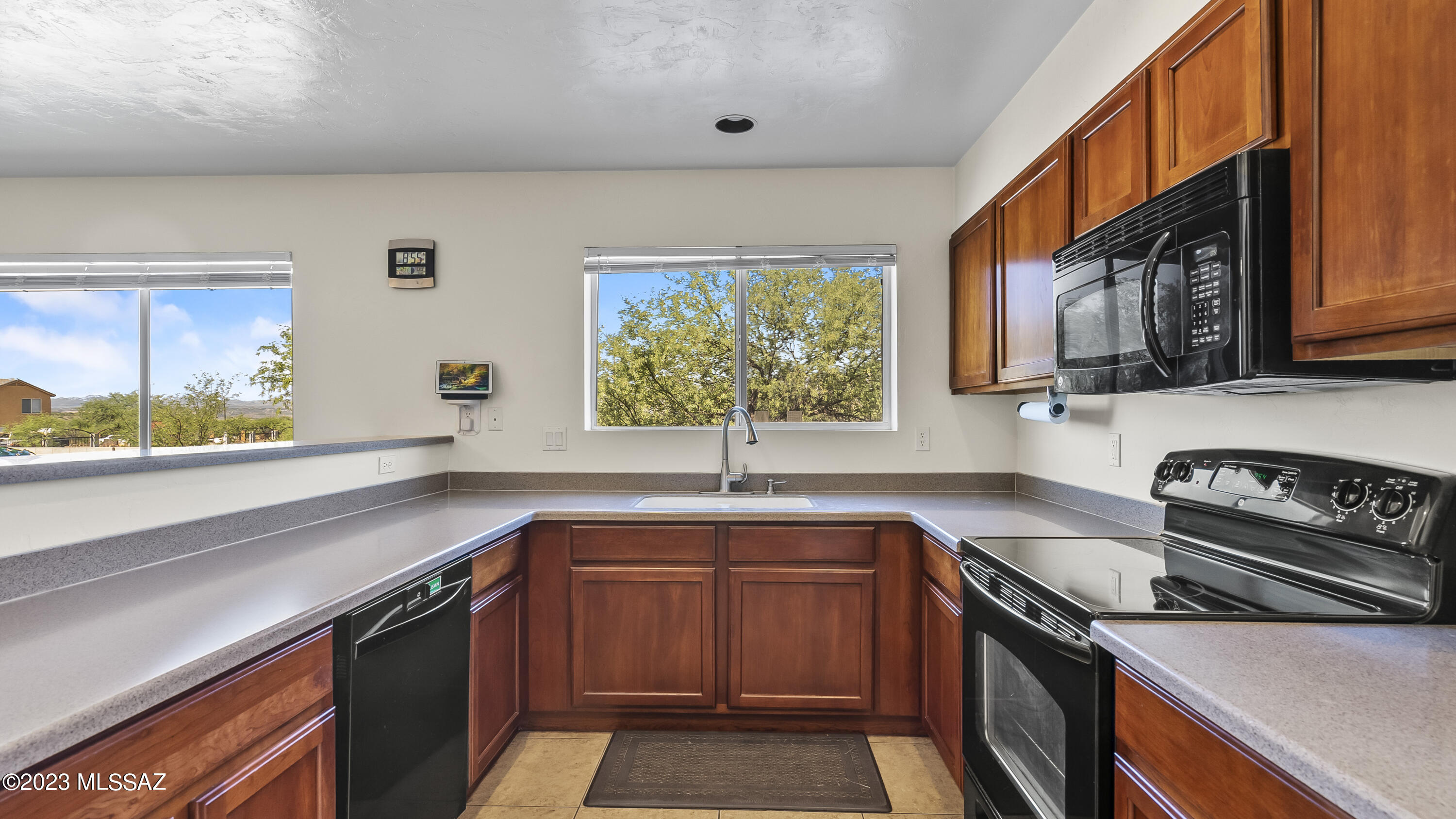1858 Tijuana Court Rio Rico, AZ 85648 - Photo 29 of 33 a kitchen with a sink stove top oven and cabinets