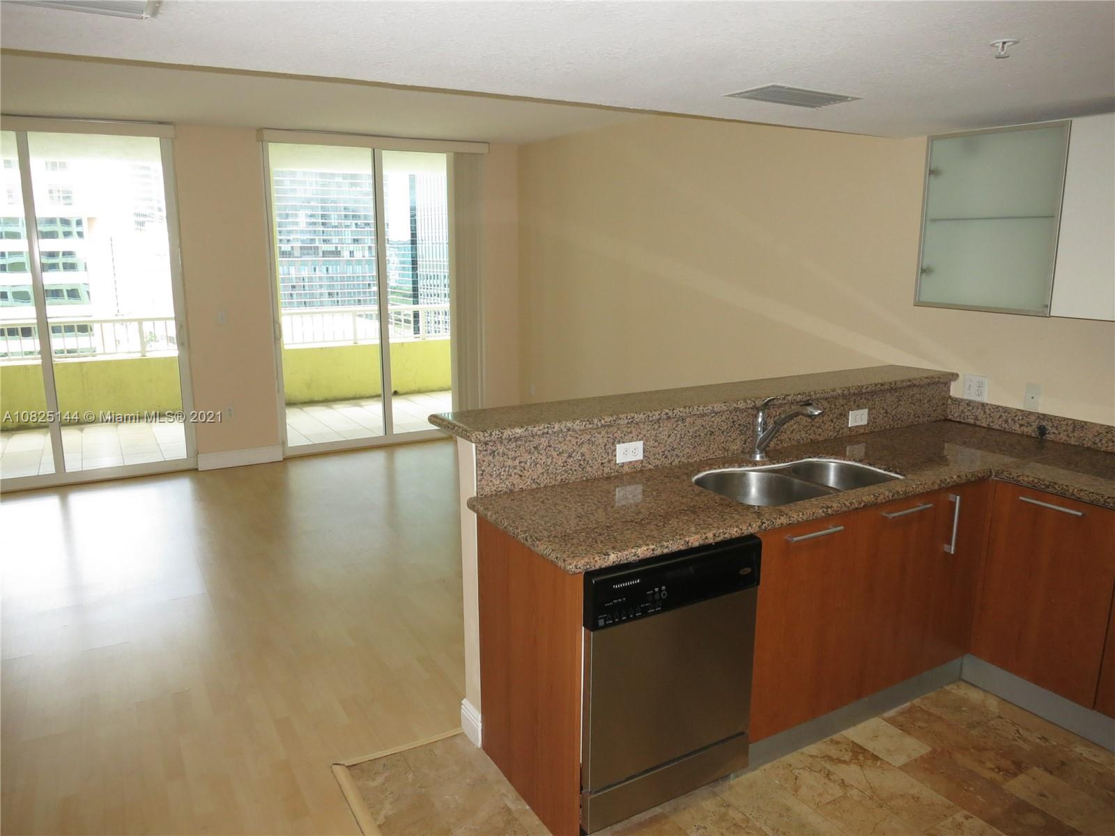 170 Southeast 14th Street, Unit 1507 Miami, FL 33131 - Photo 11 of 25 a room with granite countertop a sink and a stove top oven