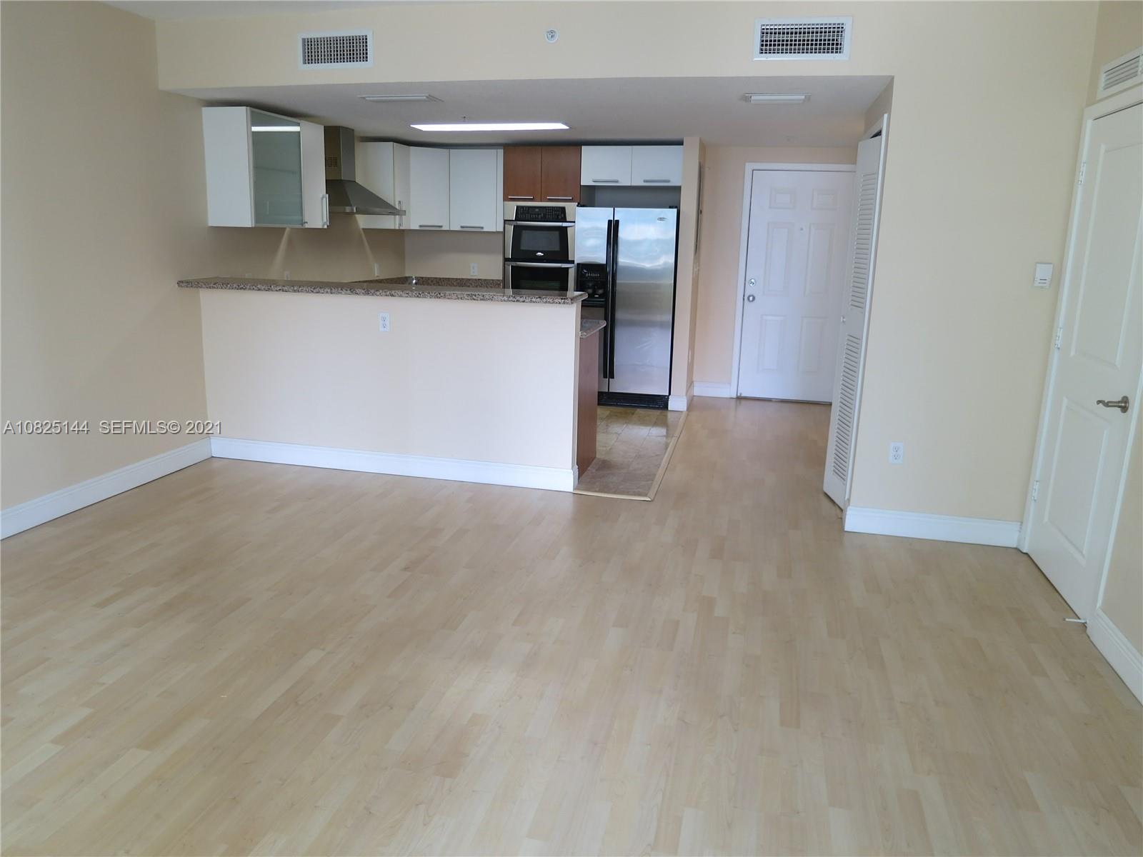 170 Southeast 14th Street, Unit 1507 Miami, FL 33131 - Photo 14 of 25 a kitchen with stainless steel appliances granite countertop a refrigerator and a stove top oven