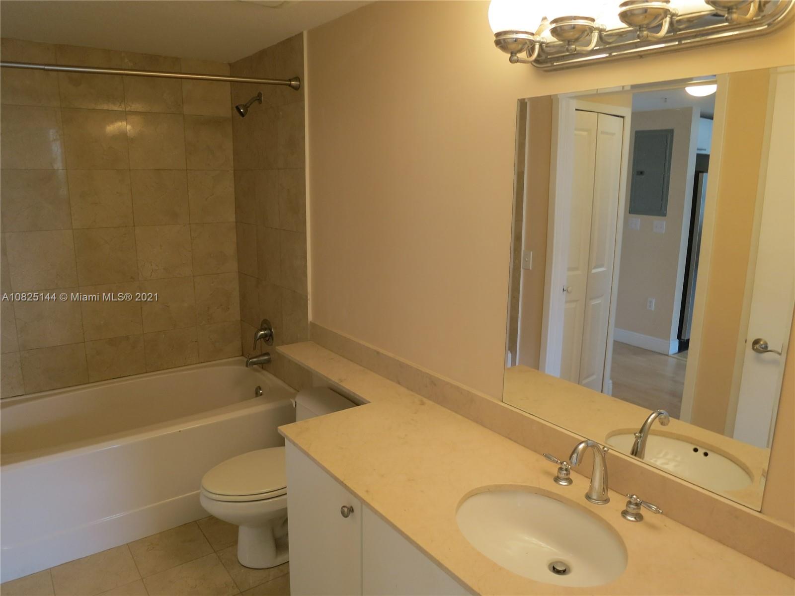 170 Southeast 14th Street, Unit 1507 Miami, FL 33131 - Photo 21 of 25 a bathroom with a sink mirror toilet and bathtub