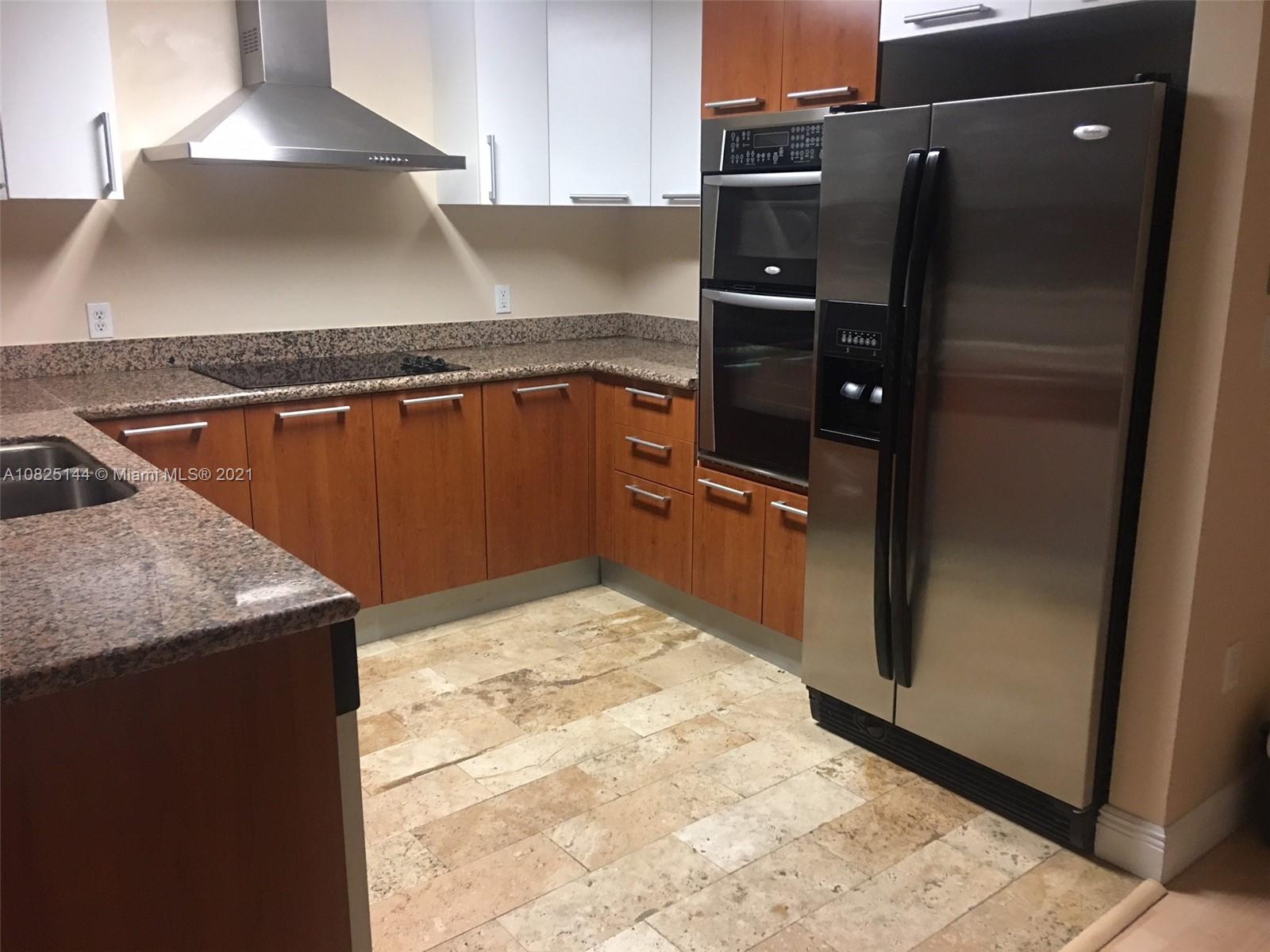 170 Southeast 14th Street, Unit 1507 Miami, FL 33131 - Photo 9 of 25 a kitchen with granite countertop a refrigerator and a stove
