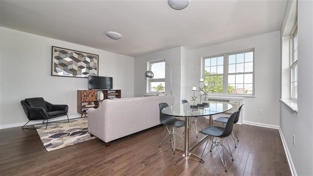 304 Broadway, Unit 108 Bayonne, NJ 07002 - Photo 4 of 6 a living room with furniture and wooden floor