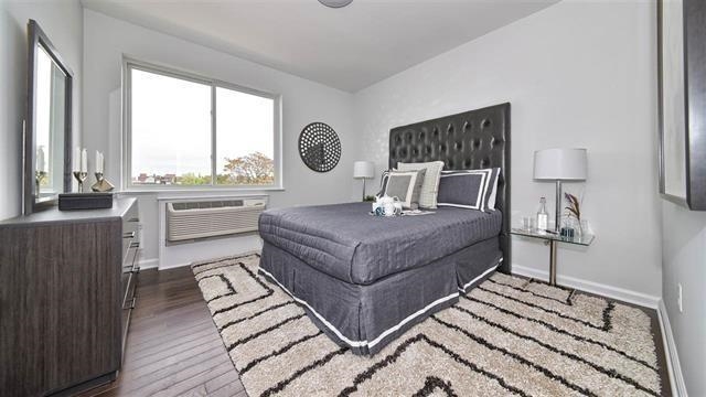 304 Broadway, Unit 108 Bayonne, NJ 07002 - Photo 6 of 6 a living room with a couch and a large window