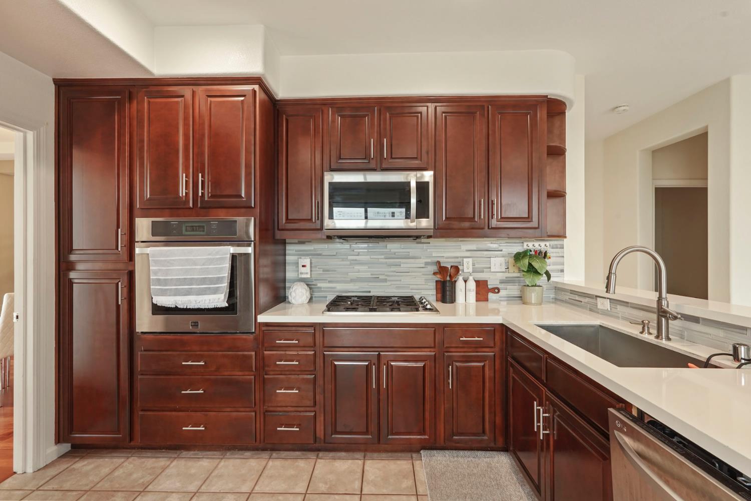 732 Pradera Way San Ramon, CA 94583 - Photo 13 of 45 a kitchen with stainless steel appliances granite countertop wooden cabinets a stove top oven a sink and dishwasher