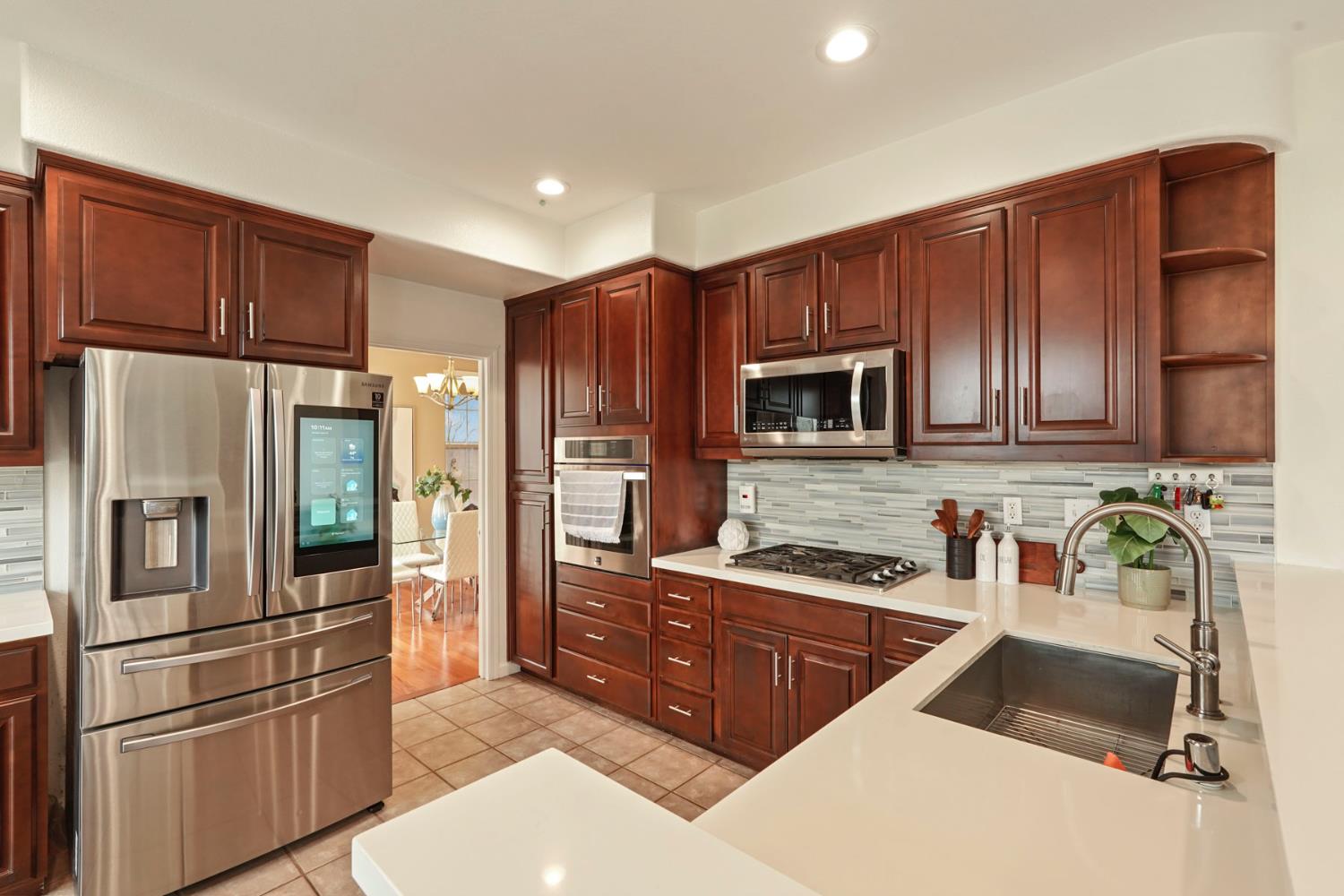 732 Pradera Way San Ramon, CA 94583 - Photo 14 of 45 a kitchen with stainless steel appliances granite countertop a refrigerator stove and oven