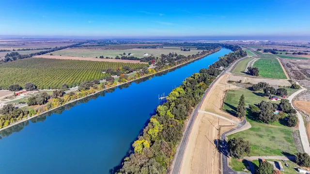 an aerial view of a house yard swimming pool and outdoor seating