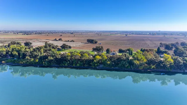 a view of a lake with houses in the back