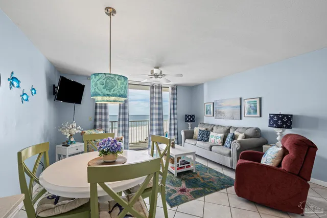 a kitchen with a stove a refrigerator and white cabinets