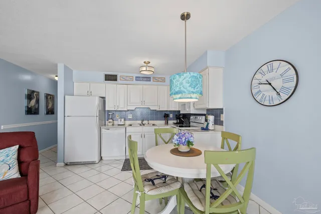 a kitchen with cabinets appliances a sink and a counter space