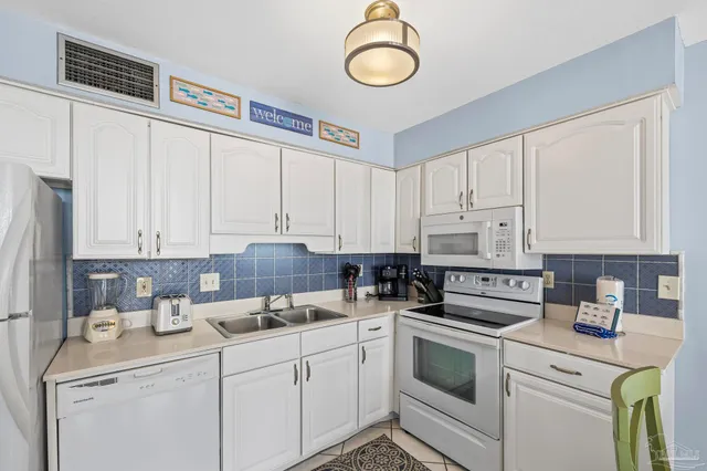 a room with furniture a washer and dryer