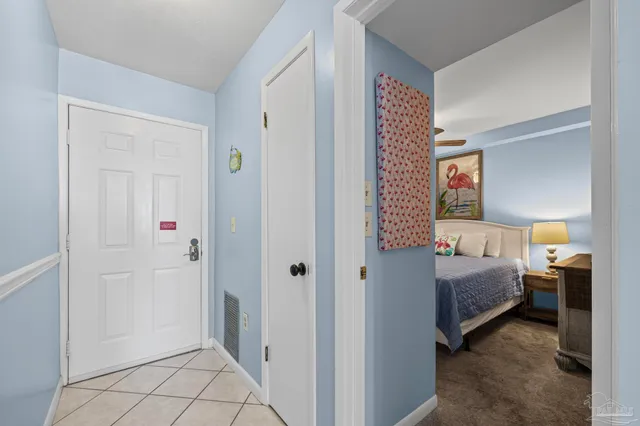 a view of a dining room with furniture and a chandelier