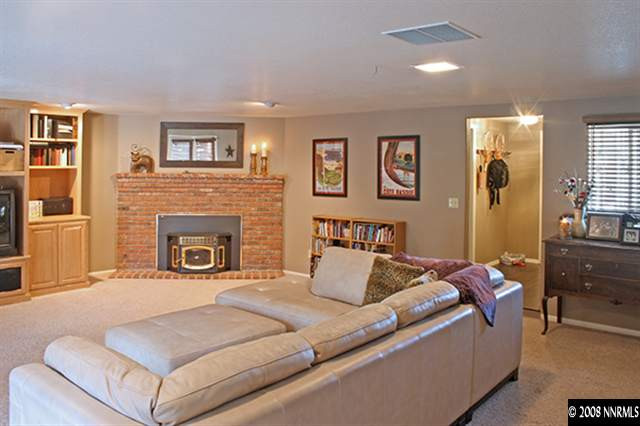 5100 Eldorado Drive Reno, NV 89519 - Photo 3 of 9 a bedroom with a large bed and a fireplace