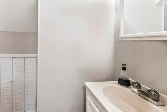 a bathroom with a sink and vanity
