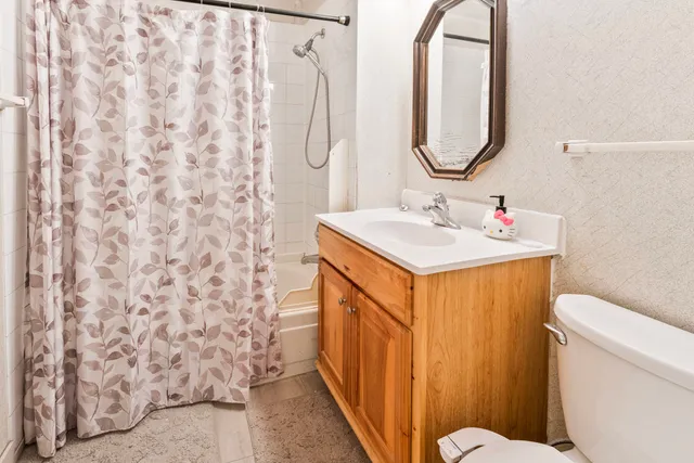 a bathroom with a sink toilet and shower