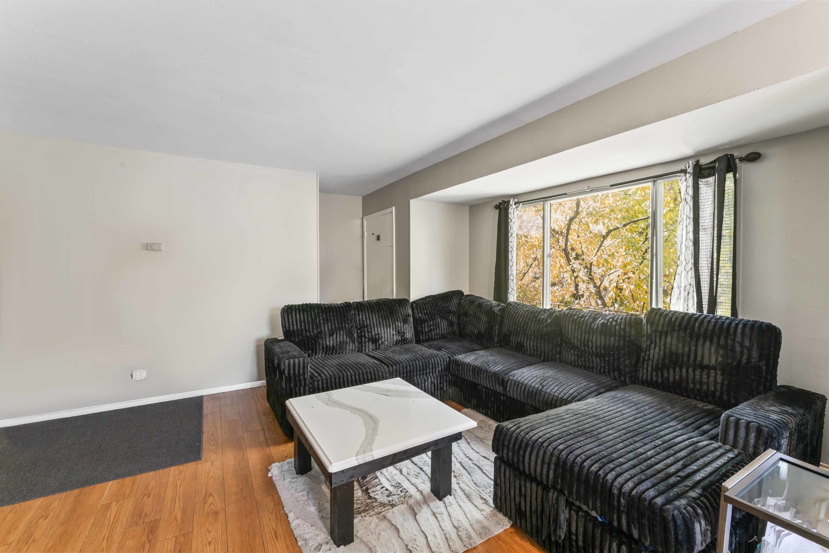 2504 West Algonquin Road, Unit 17 Rolling Meadows, IL 60008 - Photo 4 of 21 a living room with furniture and a large window
