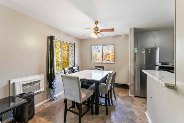 a view of a dining room with furniture and a chandelier