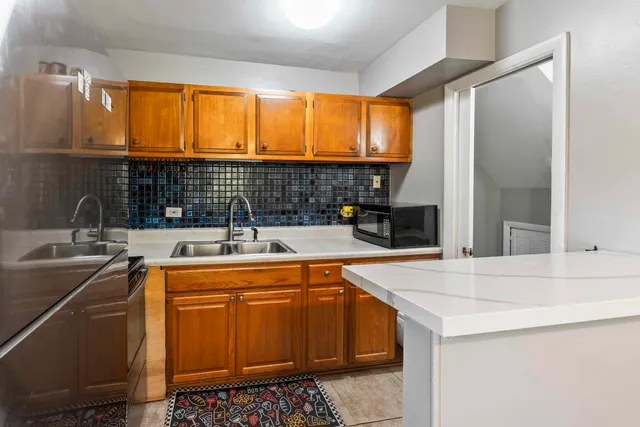 a kitchen with stainless steel appliances a sink stove and cabinets