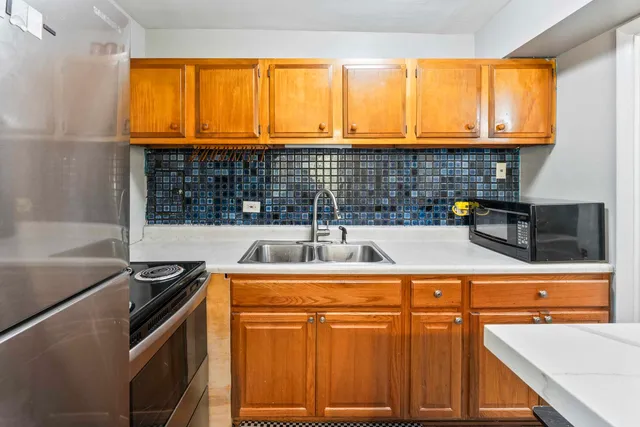 a kitchen with a sink and a stove