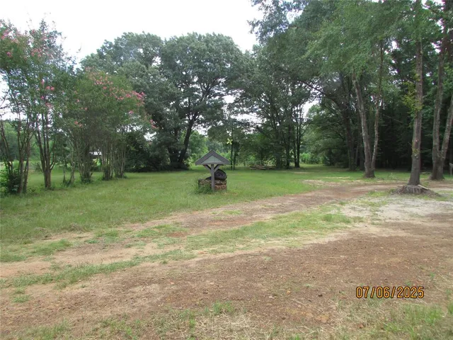 a view of field with trees in the background