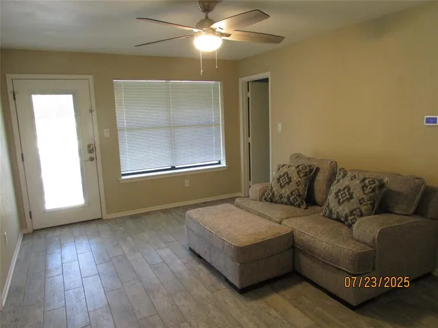 a living room with furniture and a window