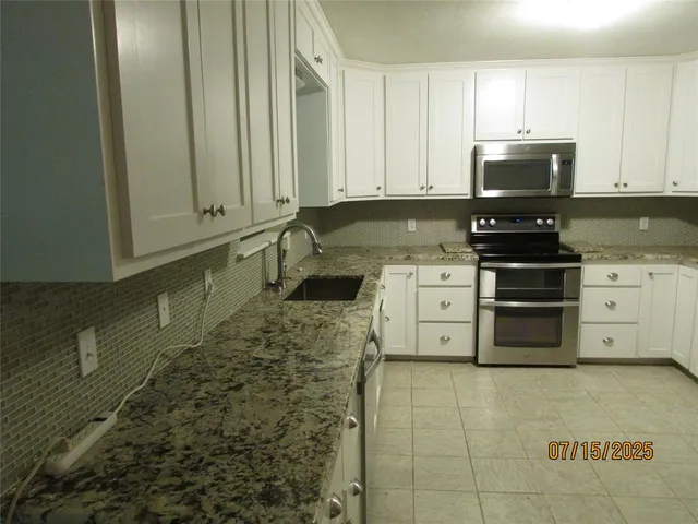 a kitchen with a stove and a microwave