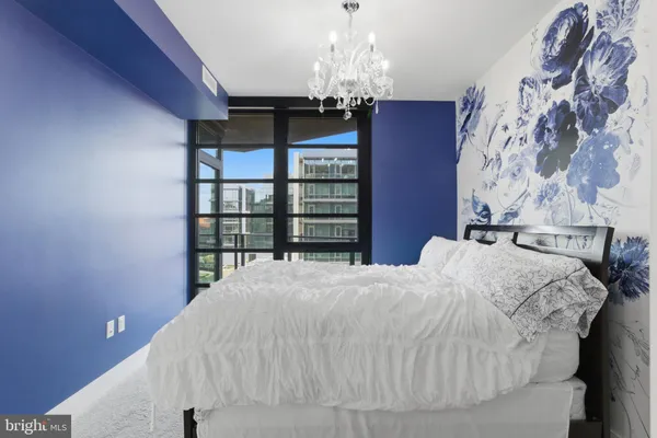 a bedroom with a bed and a chandelier