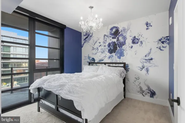 a bed sitting in a bedroom next to a window
