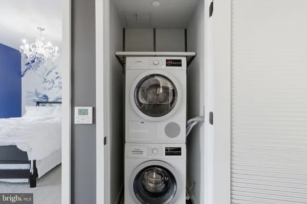 a close view of a utility room with dryer and washer