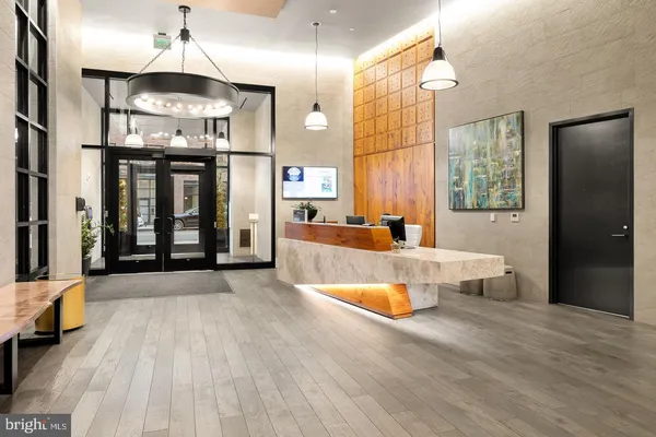 a large kitchen with stainless steel appliances a large counter top a stove and a refrigerator