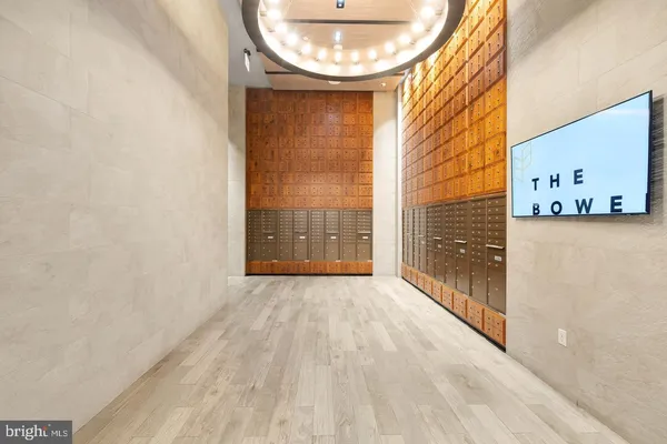 a view of an empty room with a window and kitchen view