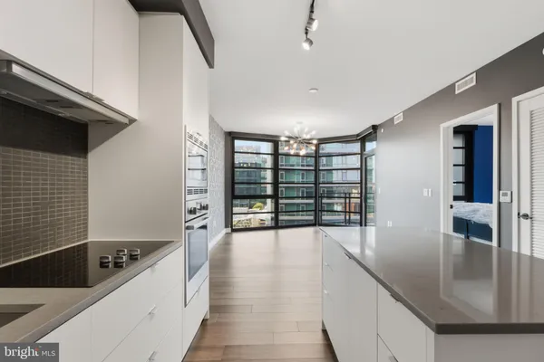 a large white kitchen with a large window