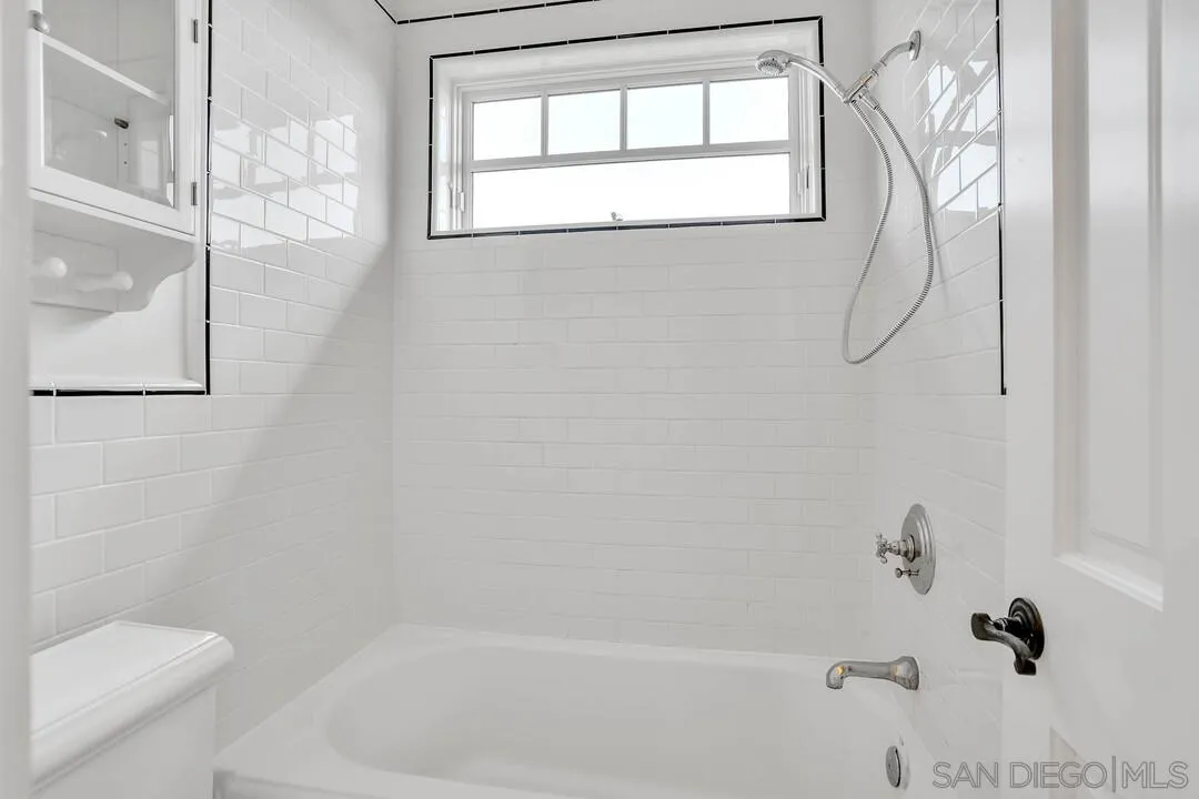 5735 Dolphin Place La Jolla, CA 92037 - Photo 42 of 75 a bathroom with a granite countertop bathtub shower and toilet